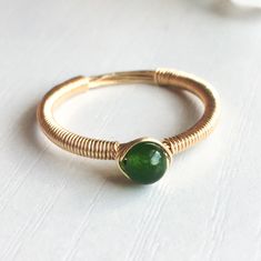 This beautifully simple ring is lovingly handmade with a Jade gemstone and a choice of 14k Gold Filled, 14k Rose Gold Filled or Sterling Silver band. M A T E R I A L S: * Dark Green Jade * 14k Gold Filled, 14k Rose Gold Filled or Sterling Silver S I Z E: * Gemstone - Approximately 4mm All of our jewellery is carefully handmade using good quality materials and handpicked gemstones, with the aim to produce quality pieces that you can love & wear for years to come. J A D E: * Talisman for Aries, Ta Wire Ring Aesthetic, Simple Wire Rings, Wire Wrap Rings, Diy Wire Jewelry Rings, Wire Jewelry Rings, Diy Jewelry Rings, Diy Ring, Green Gemstone Ring, Green Tourmaline Ring