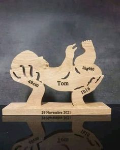 a wooden carving of a dog with the date on it's body and name