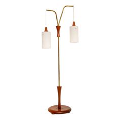 two light floor lamp with wooden base and white glass shades on the lampshade