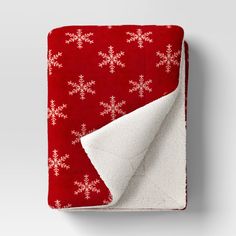 a red and white blanket with snowflakes on it