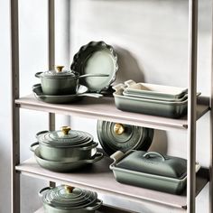 pots and pans on shelves in a kitchen