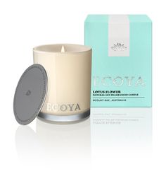 a candle that is next to a box on a white surface with the words roya in it