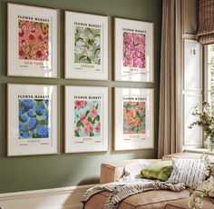 a living room filled with lots of framed art on the wall next to a window