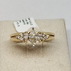 a ring with three stones in it sitting on top of a box