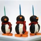 penguin cake pops are decorated with carrots and marshmallows to look like penguins