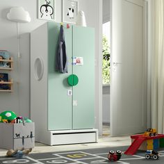 a child's room with a green and white refrigerator