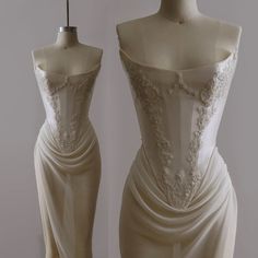 a white dress on a mannequin next to a dummy