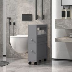 a white toilet sitting next to a sink in a bathroom with marble walls and floor