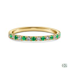 a yellow gold band with green and white stones