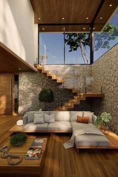 a living room filled with lots of furniture next to a stone wall and wooden floor