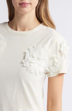 Dramatic flower appliqués add textural elegance to this lightweight and soft stretch-cotton top. Crewneck Short sleeves 60% rayon, 40% cotton Hand wash, line dry Made in the USA Elegant Off White Cotton Top, Spring Off White Crew Neck Tops, Elegant Cotton T-shirt For Spring, Elegant White T-shirt For Spring, Chic Cream Tops With Floral Embroidery, White Floral Embellished Tops For Summer, Feminine White T-shirt For Spring, White Tops With Floral Applique, White Crew Neck Top With Floral Applique