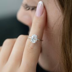 a close up of a person with a ring on their finger and a diamond in the other hand