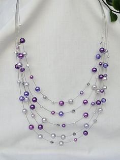 Beautiful handmade Multi strand floating necklace.  This necklace has been made using different shades of purple faux pearls and Austrian crystal Bicone beads, threaded onto a nylon coated stainless steel wire, finished off with a lobster clasp closure and a 5cm extension chain for added length if needed. The necklace is available in two lengths, either 42cm or 48cm, not including the extension chain Your necklace will be packaged in a lovely gift box, perfect for a gift. -Please note that stand Pearl Necklace Layered, Multi Strand Beaded Necklace, Diy Collier, Floating Necklace, Necklace Layered, Beaded Necklace Diy, Necklace Purple, Purple Necklace, Wire Necklace