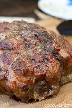 a piece of meat sitting on top of a wooden cutting board