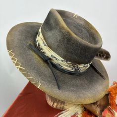 *PRICE INCLUDES $15 HAT BOX* Premium Wool Felt 4 1/4 Crown, 3 3/4 inch brim Custom Color, Distressing, Band and Accessories Dri-lex sweatband for added comfort Colors may vary slightly. Although each hat is unique a similar hat can be made in various sizes. All Sales Final Handmade Country Style Fedora With Flat Crown, Handmade Western Fedora With Flat Crown, Handmade Country Fedora With Flat Crown, Western-themed Fedora Hat With Feathers, Western Wide-brim Fedora With Feathers, Womens Fedora Hat, Womens Fedora, Hat Box, Fedora Hat