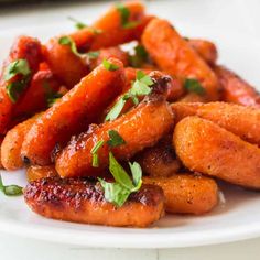 the plate is full of carrots with parsley on top