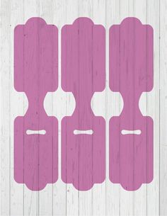 four pieces of wood with pink paint on them