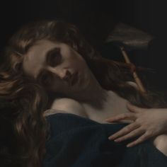 a painting of a woman wrapped in a blanket with an arrow sticking out of her shoulder