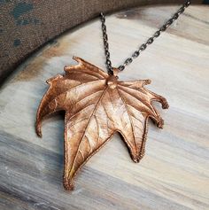 Real Sycamore leaf is copper electroformed and has an added patina. The pendant is then finished with a coating of clear enamel spray to protect the color and also to prevent the copper from discoloring skin from oxidation. *24 inch chain with a lobster clasp is included. Chain is made of iron with a dark silver color plating.  *You will receive this exact copper leaf pendant.  CREATING PROCESS  Handmade and created from a real leaf that I have found outside or from one of my plants. Each piece goes through the process drying, clear coat, conductive paint, and then electroformed; which is basically copper plating organic or non metal material. Then I'll give it a few finishing touches. Once completed I cover it with a protective clear coating to stop further oxidation. Bronze Patina Copper Necklace, Bronze Copper Necklace With Patina, Hand Cast Copper Pendant Necklace, Hand Cast Copper Pendant Necklaces, Bronze Copper Leaf-shaped Jewelry, Electroformed Leaf-shaped Copper Jewelry, Sycamore Leaf, Copper Plating, Real Leaf