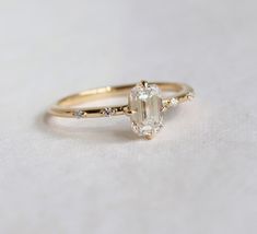 an engagement ring with a large oval cut diamond in the center and side stones on each band