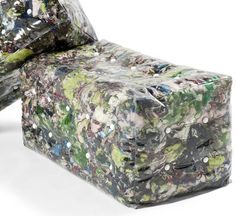 an upholstered chair covered in plastic wrap