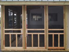 a screened porch with sliding glass doors on the front and back sides, in an enclosed area