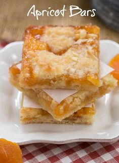 three pieces of apricot bars on a white plate