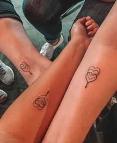 two people with matching tattoos on their legs