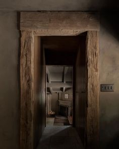 an open door leading into a room with wooden walls