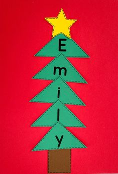 a christmas tree made out of paper with the word merry written on it