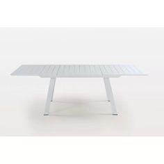 a white table sitting on top of a white floor