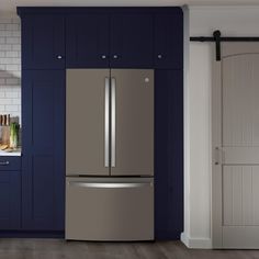 a large metallic refrigerator freezer sitting inside of a kitchen next to blue cupboards