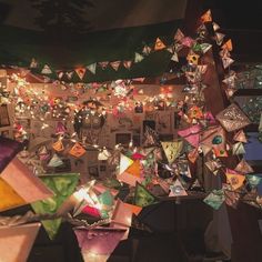 a room filled with lots of different colored lights and decorations hanging from the ceiling above