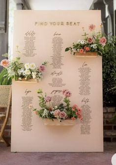 a seating chart with flowers on it is displayed in front of a sign that says find your seat