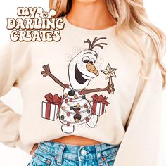 a woman wearing a snowman sweatshirt and jean shorts with her hands on her hips