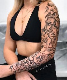 a woman with tattoos on her arm sitting down