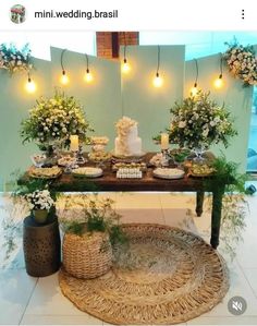 a table topped with lots of food and greenery next to a vase filled with flowers