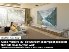 a woman sitting on a couch in front of a large painting with the caption get a massive 120 picture from a compact projector that starts close to your wall