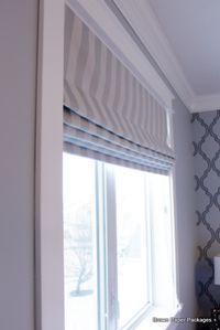 a kitchen with a stove top oven sitting next to a wallpapered wall and window