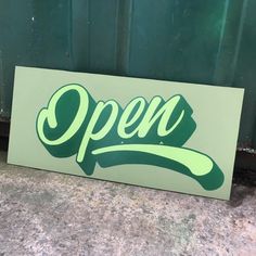 a green sign that says open on it