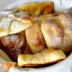 a basket filled with pastries covered in powdered sugar