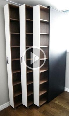 an empty room with two tall bookshelves and a door open to reveal the closet