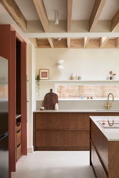 a kitchen with wooden cabinets and white counter tops