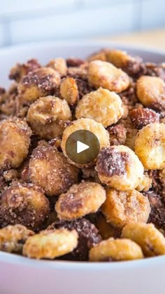 a white bowl filled with nuts on top of a table