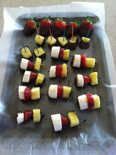 strawberries and bananas are arranged on skewers