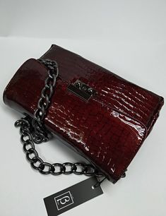 An elegant classic style bag with a strong scent of the legendary original designs that marked deeply the modern fashion, made of high quality genuine greek calf leather, processed properly in order to resemble croc leather. The bag's inner space is seperated in three (3) divisions, as also a zipped pocket is included. The chain is made of black nickel and it's proper for the use of the bag as a Shoulder Bag. The bag includes a safety lock, which can be opened simply via sliding the small round Leather Baguette Evening Bag With Phone Pocket, Luxury Leather Clutch With Mobile Phone Bag, Formal Leather Baguette Bag For Mobile Phone, Elegant Crossbody Baguette Bag With Chain Strap, Leather Top Handle Baguette Bag As Gift, Rectangular Business Shoulder Bag With Chain Strap, Elegant Soft Leather Baguette Bag Clutch, Elegant Soft Leather Clutch Baguette Bag, Formal Mobile Phone Clutch Baguette Bag