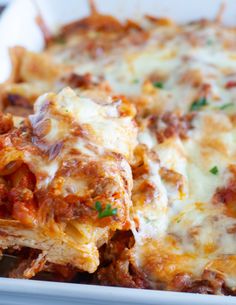 lasagna casserole with meat and cheese in a white dish on a wooden table