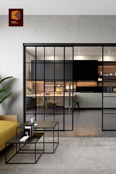 an open concept living room and kitchen with glass doors that lead into the dining area