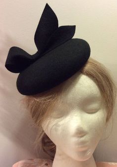 Currently Ready to ship - ship out in 3-5 days. OVERVIEW -------------- This design was inspired by those of Duchess of Cambridge - Kate Middleton's fascinators. This hat would look much better if you wear it on the right side of the head. DETAILED DESCRIPTION --------------------------------- This listing is for a chic handmade 100% Merino wool fascinator hat in BLACK color. It features a cute looped bow - full of elegance and character.  I could make this design in more than 100 colors, just message me or leave me a note during checkout.  Wool fascinators are not just for the royalty or the high society. Everyone looks at their best wearing them and they are appropriate on nearly all occasions. They are not flashy or swanky: instead, they are the embodiment of a timeless elegance back in Handmade Fitted Vintage Fascinator, Handmade Formal Hats, Vintage Black Handmade Top Hat, Handmade Fitted Hats For Formal Occasions, Handmade Fitted Formal Hats, Formal Fitted Handmade Hats, Fitted Black Hat With Structured Crown, Elegant Black Mini Hats As Gifts, Classic Fascinator Hat