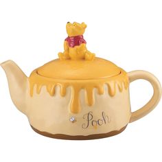 a winnie the pooh teapot with honey dripping on it